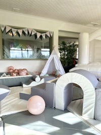 a room with a play area and balloons